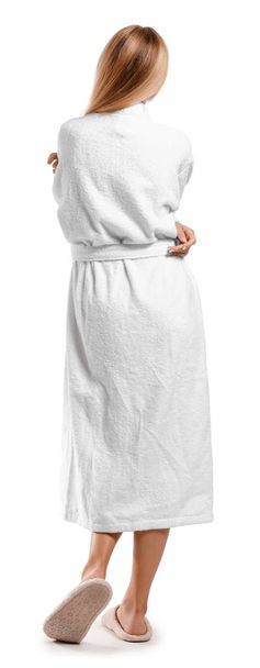 Beautiful young woman in bathrobe on white background, back view - Photo, Image