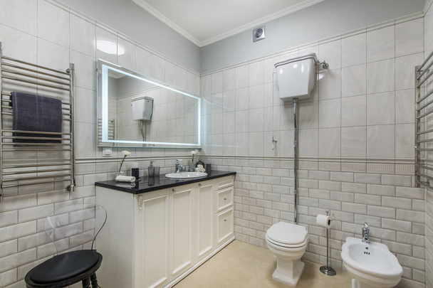 Beautiful modern bathroom with large backlit illuminated mirror - Фото, изображение