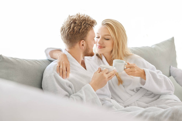Morning of happy young couple drinking coffee at home - Photo, Image