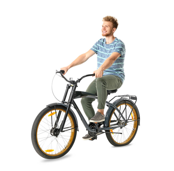 Nuori mies ratsastus polkupyörällä valkoista taustaa vasten
 - Valokuva, kuva