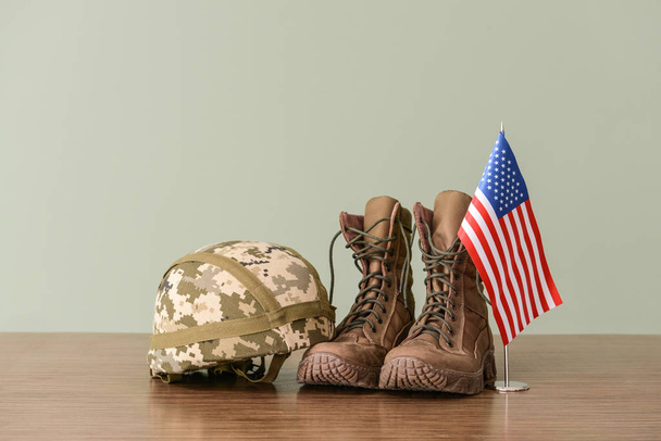 Military helmet, boots and USA flag on table - Photo, Image