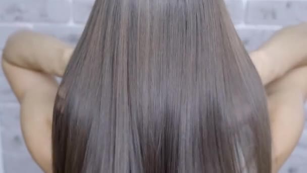 Result after lamination and hair straightening in a beauty salon for a girl with brown hair. hair care concept - Кадры, видео
