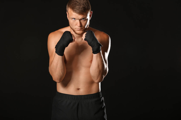 Strong male boxer on dark background - Fotó, kép