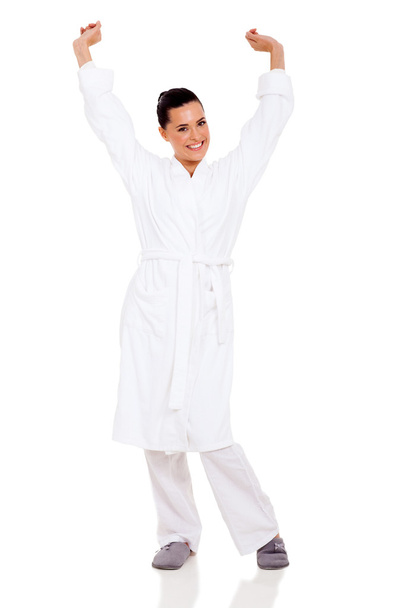young woman in pajamas stretching arms - Foto, Imagen