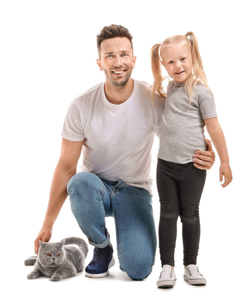 Happy father and daughter with cute cat on white background - Foto, afbeelding