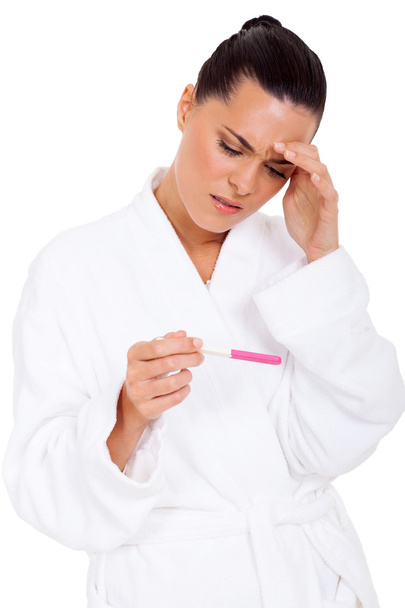 confused woman looking at pregnancy test result - Фото, зображення
