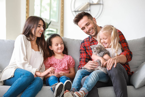 Happy family with cute cat resting at home - Photo, Image