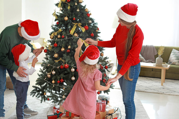 šťastná rodina zdobení vánoční stromeček doma - Fotografie, Obrázek
