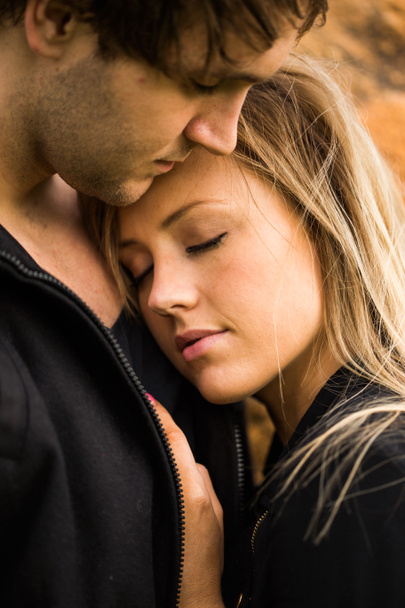 Romantic, tender moment of a young attractive couple. Pretty adorable girl closing her eyes - Photo, Image