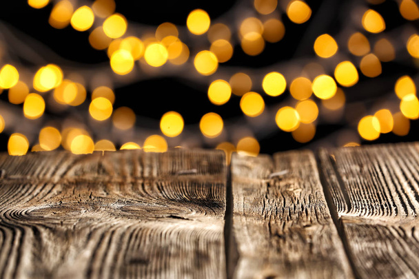 Closeup view of table against blurred lights - Fotó, kép
