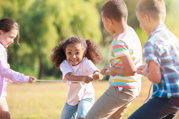 Grupo de crianças puxando corda no parque
 - Foto, Imagem
