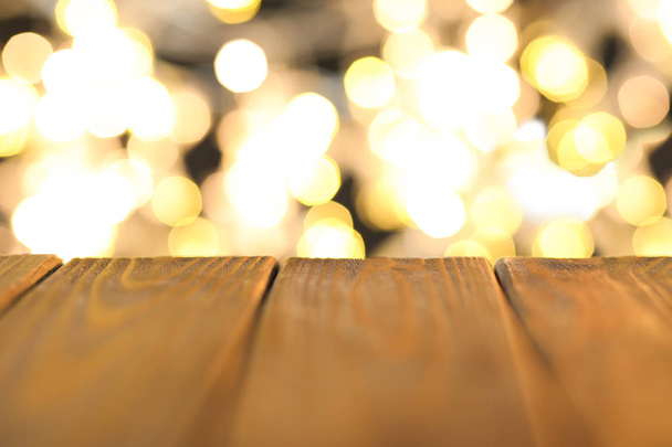 Wooden table and colorful defocused lights - Foto, Imagen