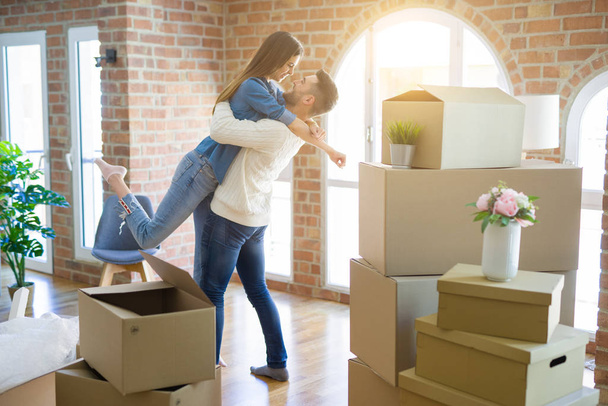 happy man and woman moving to new flat - Photo, image