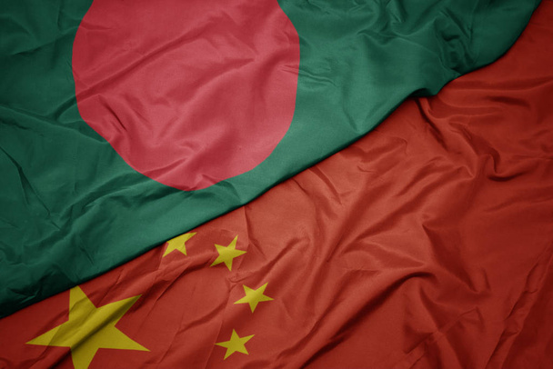 ondeando colorida bandera de China y bandera nacional de bangladesh
. - Foto, Imagen
