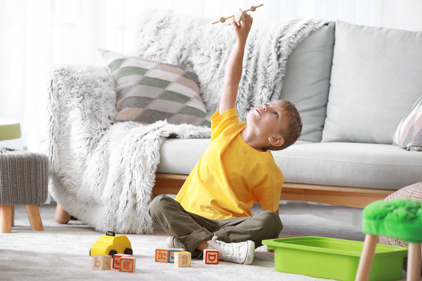 Cute little boy playing with toys at home - Fotoğraf, Görsel