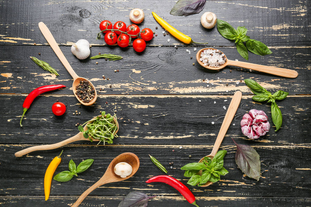 Different fresh herbs and spices on dark wooden background - 写真・画像