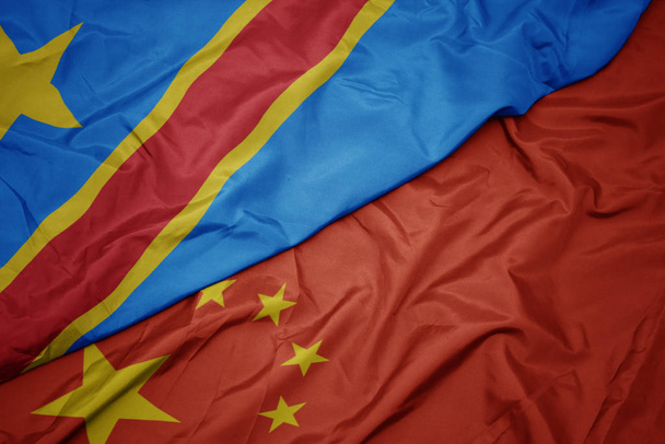 waving colorful flag of china and national flag of democratic republic of the congo. - Photo, Image