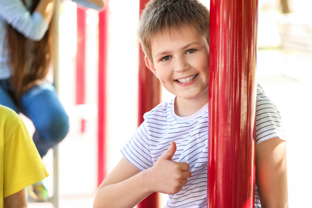 Cute little boy showing thumb-up on playground - Photo, Image