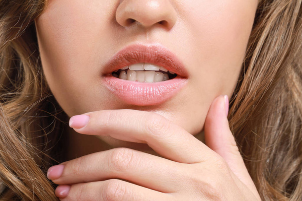 Young woman with beautiful lips, closeup - 写真・画像