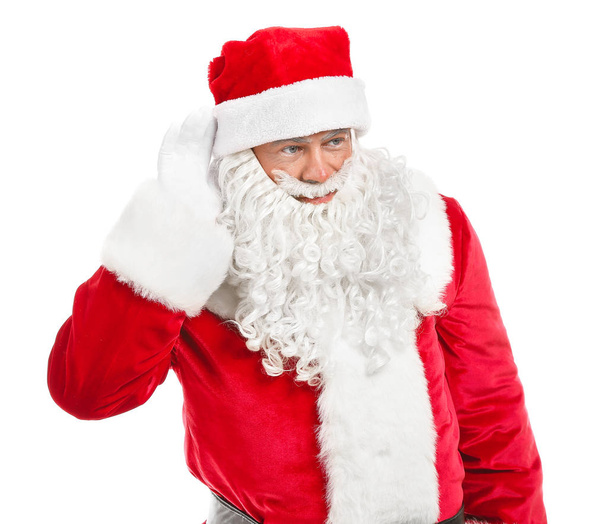 Retrato de Papai Noel tentando ouvir algo sobre fundo branco
 - Foto, Imagem