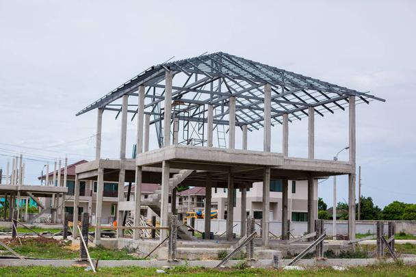 Home under construction using steel frames against. New resident - Photo, Image