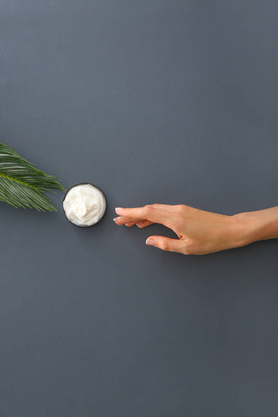 Female hand with natural cream on grey background - Foto, Bild