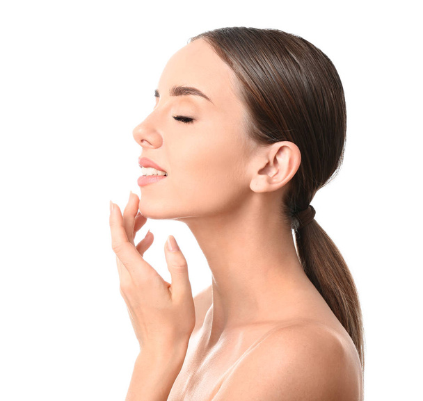 Beautiful woman massaging her face against white background - Foto, afbeelding