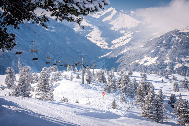 Mayrhofen, Austria Zillertal Valley amid snowy fir trees and ski lift - Photo, Image