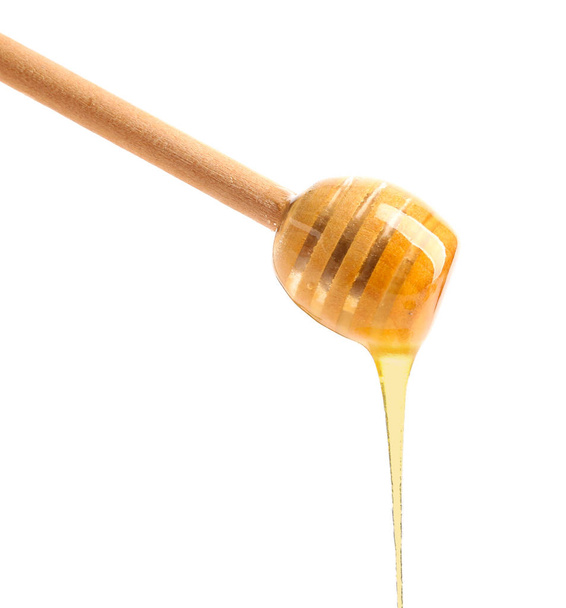 Wooden honey dipper on white background - Photo, Image