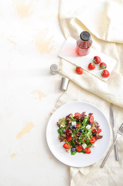 Plate with fresh tasty salad on table - Фото, изображение