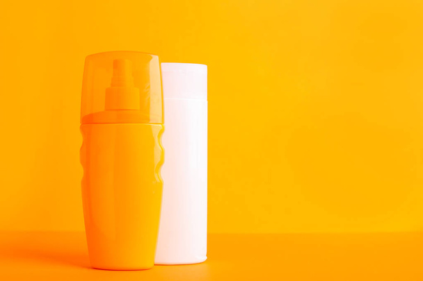 Bottles of sun protection cream on color background - Photo, Image