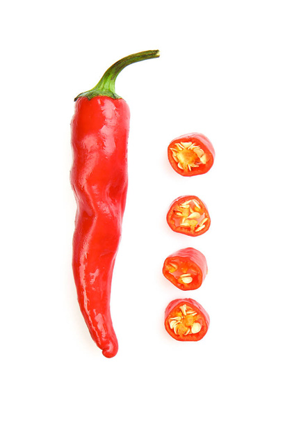 Hele en snijd rode chili pepers op witte achtergrond - Foto, afbeelding