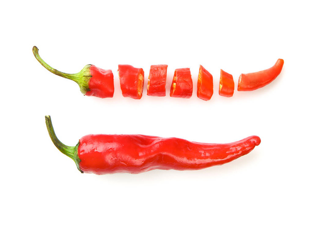 Whole and cut red chili peppers on white background - Photo, Image