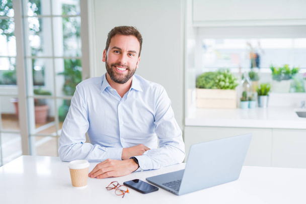 Handsome business man working using computer laptop and smiling - Photo, Image