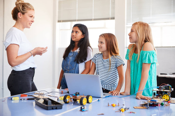 Three Female Students With Teacher Building Robot Vehicle In After School Computer Coding Class - Valokuva, kuva