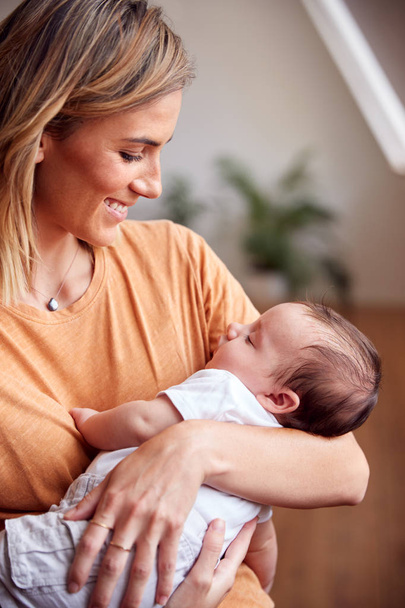 Loving Mother Holding Newborn Baby At Home In Loft Apartment - Photo, image