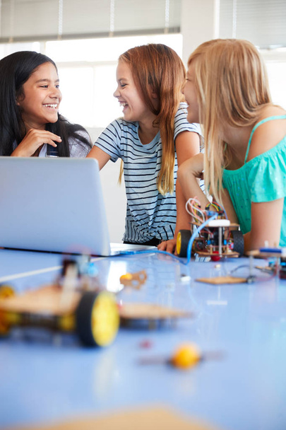 Three Female Students Building And Programing Robot Vehicle In After School Computer Coding Class - Foto, afbeelding