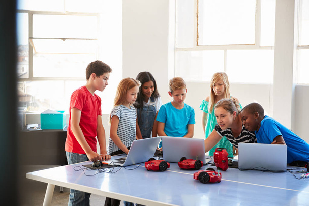 Group Of Students In After School Computer Coding Class Learning To Program Robot Vehicle - Fotó, kép