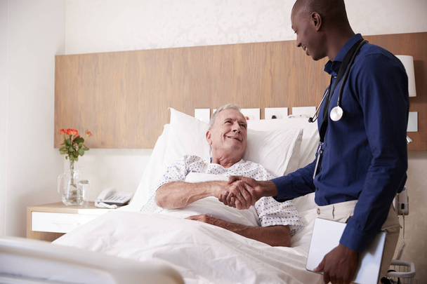Doctor Shaking Hands With Senior Male Patient In Hospital Bed In Geriatric Unit - Photo, Image