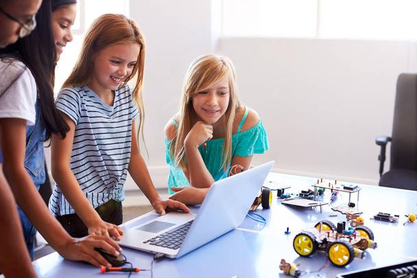 Three Female Students With Teacher Building Robot Vehicle In After School Computer Coding Class - Foto, imagen