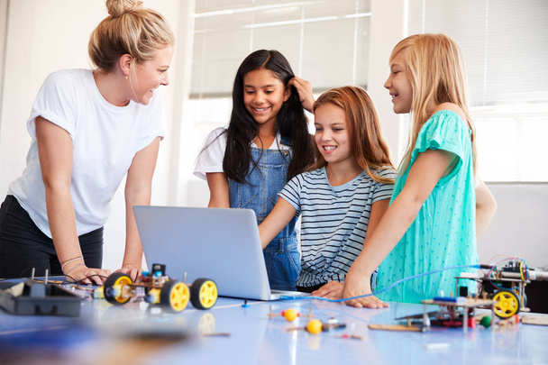 Three Female Students With Teacher Building Robot Vehicle In After School Computer Coding Class - Foto, Imagem