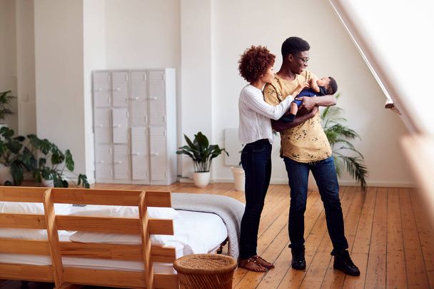 Loving Parents Holding Newborn Baby At Home In Loft Apartment - Photo, image