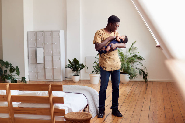 Loving Father Holding Newborn Baby At Home In Loft Apartment - Φωτογραφία, εικόνα