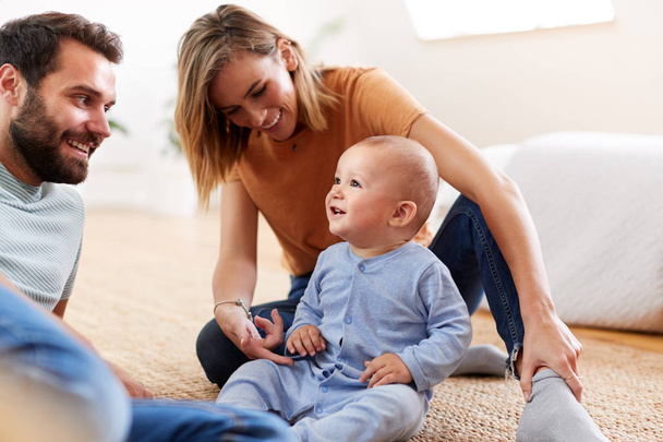 Parents Sitting On Floor At Home Playing With Baby Son - Φωτογραφία, εικόνα