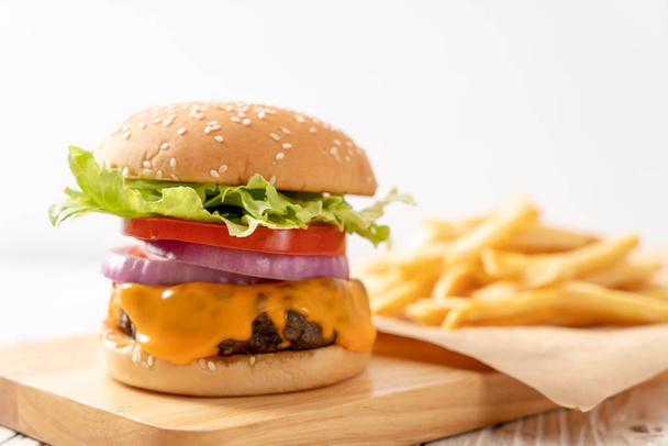 fresh tasty beef burger with cheese and french fries - Fotó, kép