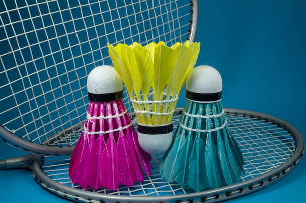 Feathered shuttlecocks and badminton rackets - Photo, Image