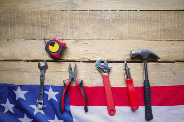 Handy tools with American flag on wooden table - Φωτογραφία, εικόνα