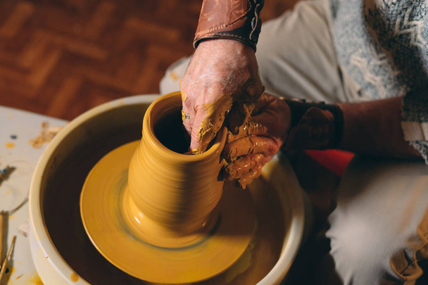 Pottery workshop. A senior man makes a vase of clay. Clay modeling - Fotoğraf, Görsel