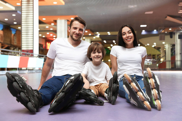 Happy family spending time at roller skating rink - Fotoğraf, Görsel