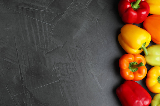 Fresh ripe bell peppers on grey table, top view. Space for text - Foto, immagini